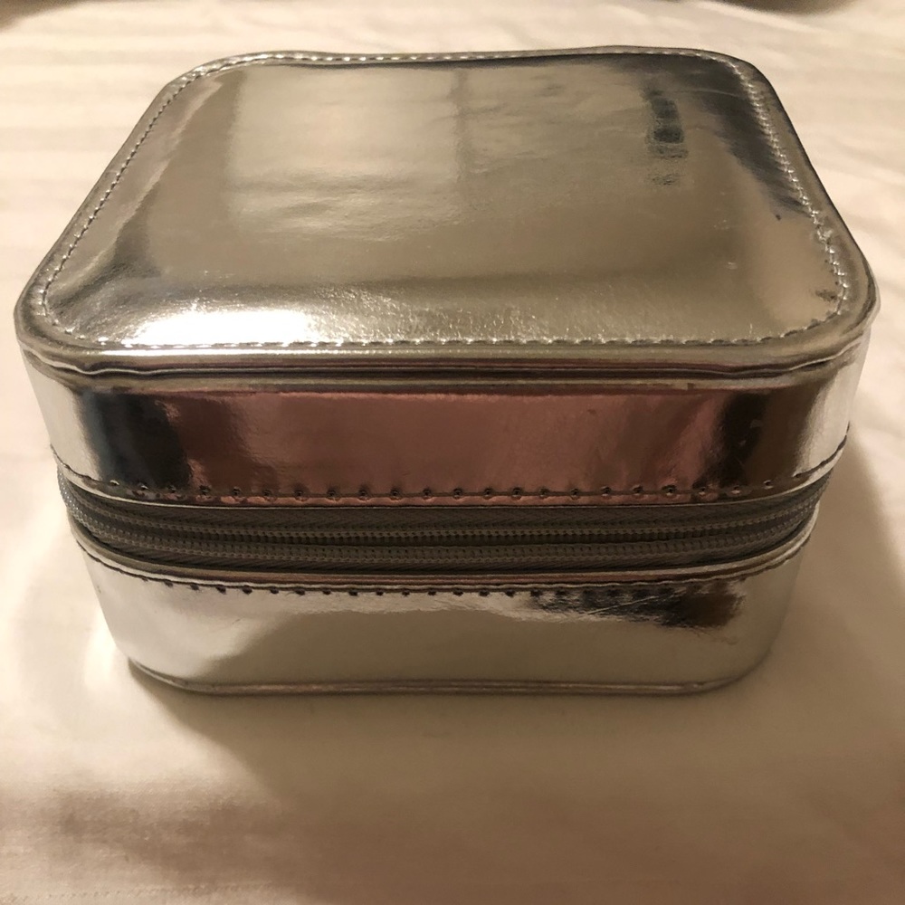 Jewelry box to prevent tarnish. Includes 2 pairs of cubic zirconium earrings.
